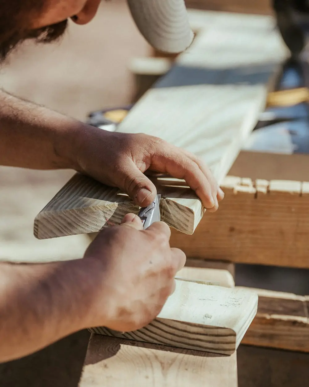Craftsman shaping a wooden edge by hand with a block plane