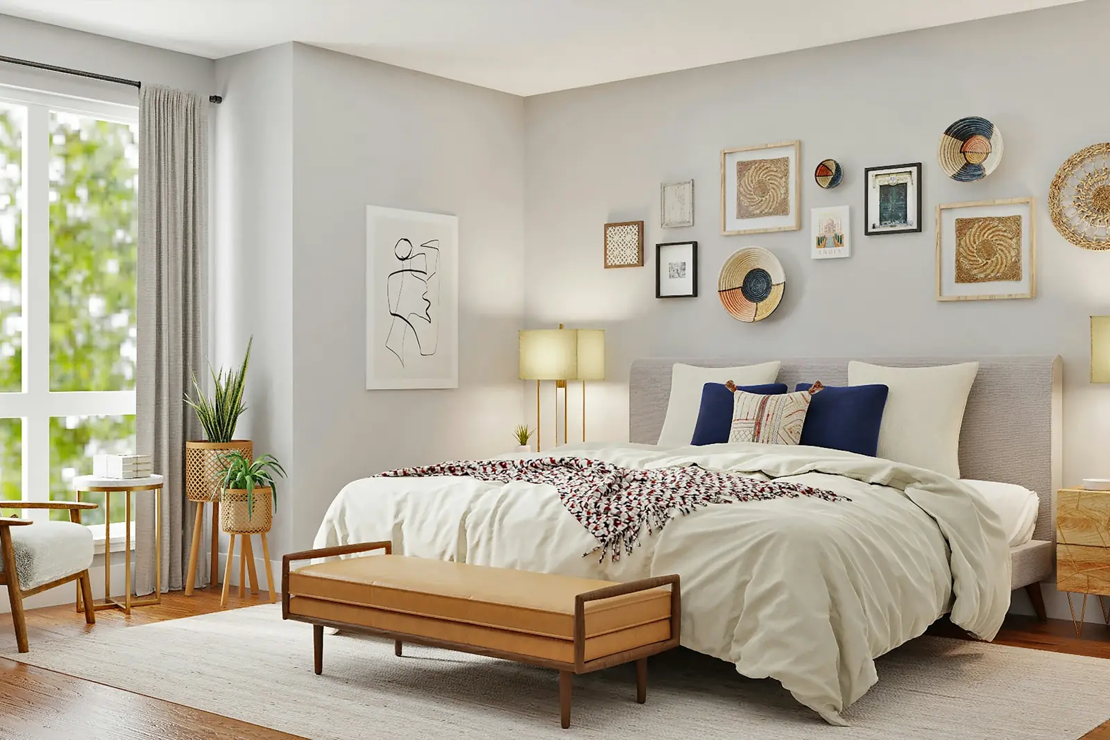 Calm bedroom with a gallery wall, layered bedding and a wooden bench