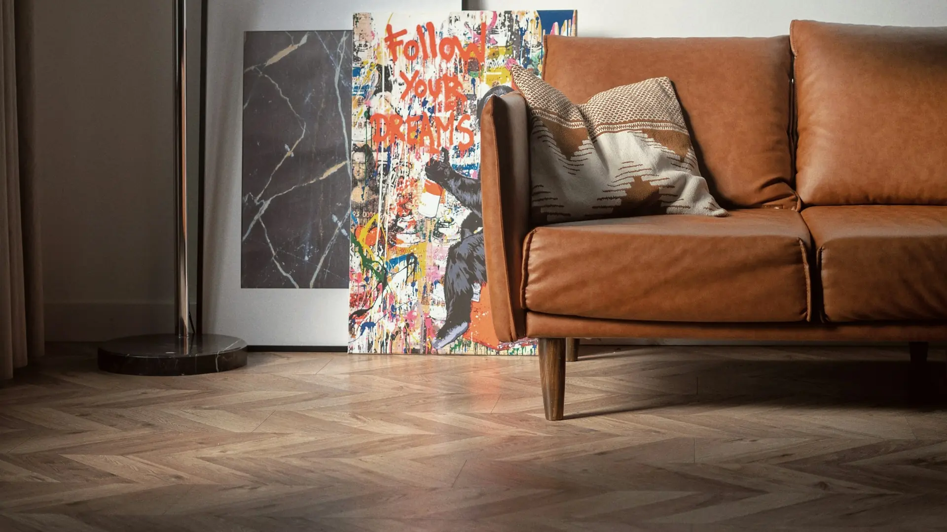 Brass arc floor lamp over a cognac leather sofa in a softly lit room