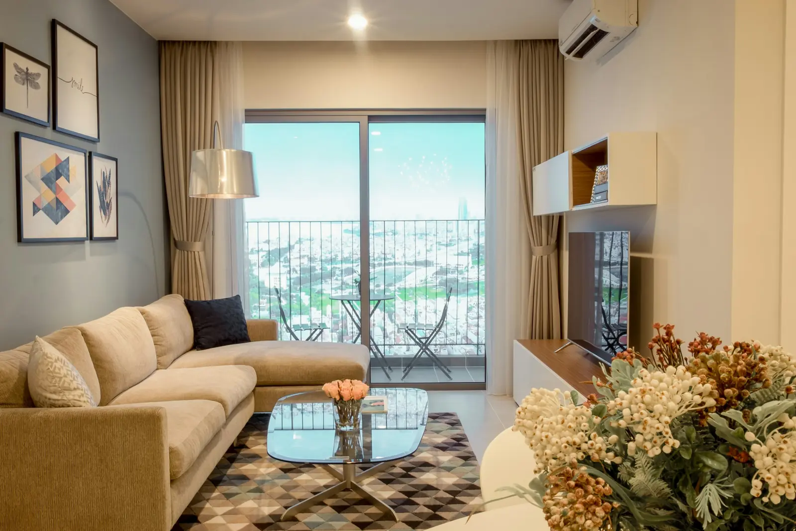 Compact apartment living room with a mustard sofa and a balcony view