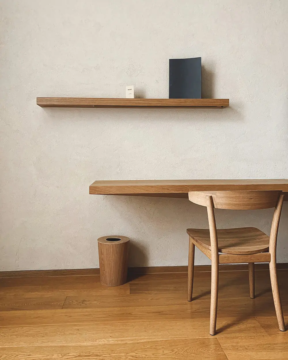 Minimal floating solid-wood wall desk with a matching shelf and chair