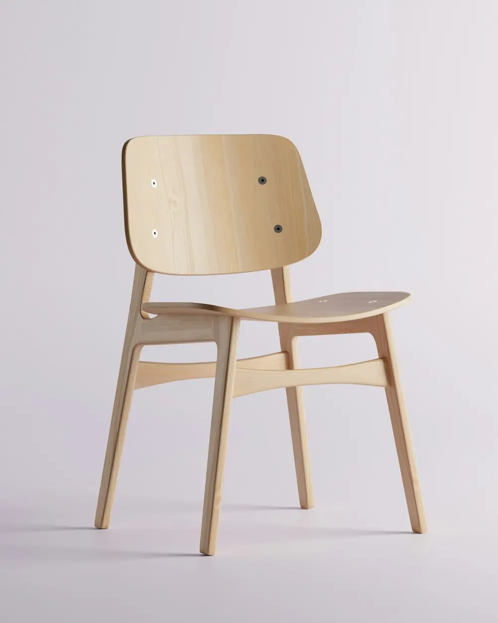 Solid ash dining chair with a moulded backrest on a pale studio backdrop