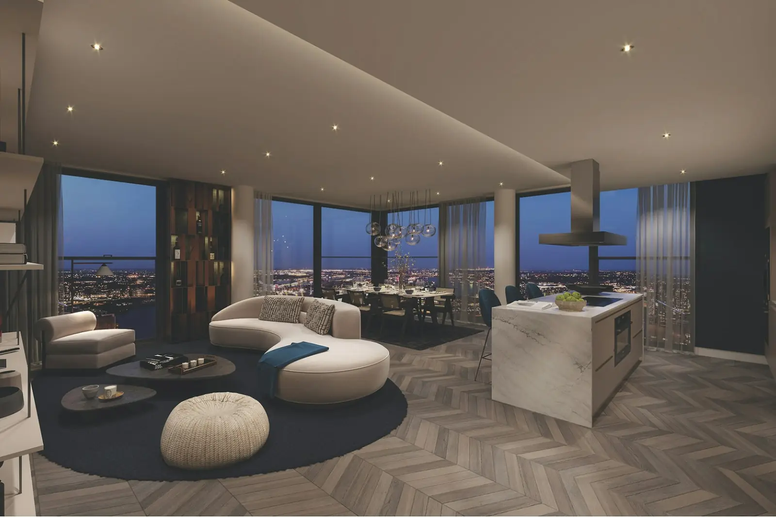 Penthouse living room with a curved sofa, round rug and city lights through the windows