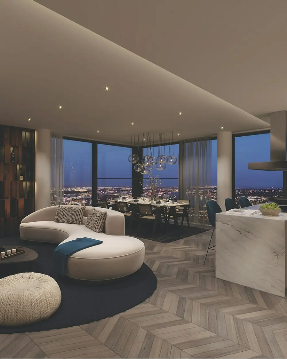Penthouse living room with a curved sofa, round rug and city lights through the windows