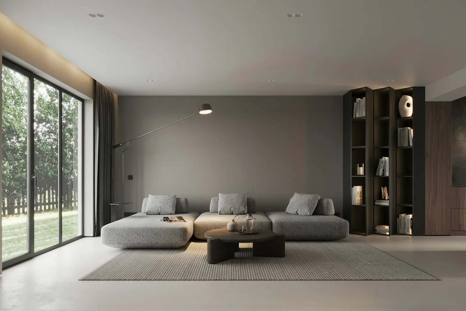 Minimal grey living room with a low modular sofa, soft daylight and pared-back décor